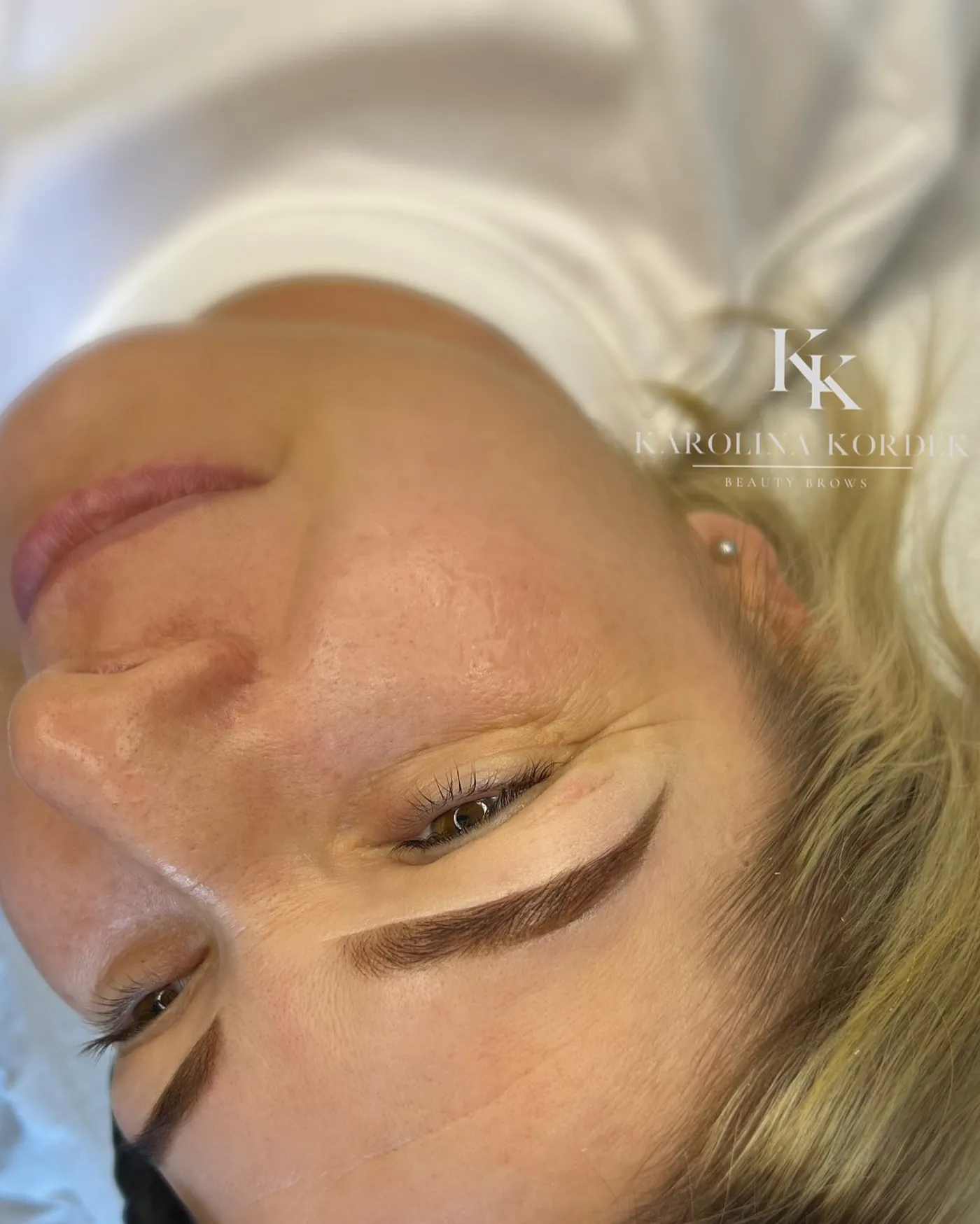 Close-up of soft ombre brows during a treatment